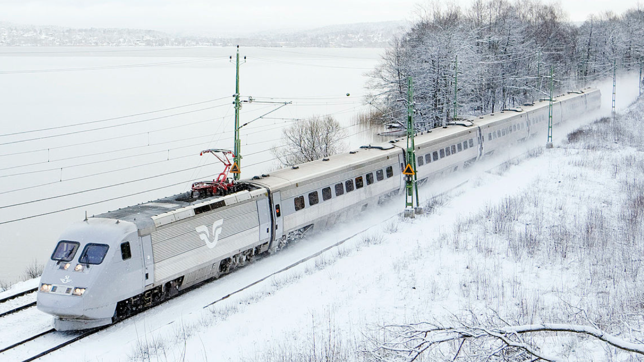 Ett tåg på räls i vinterväder.
