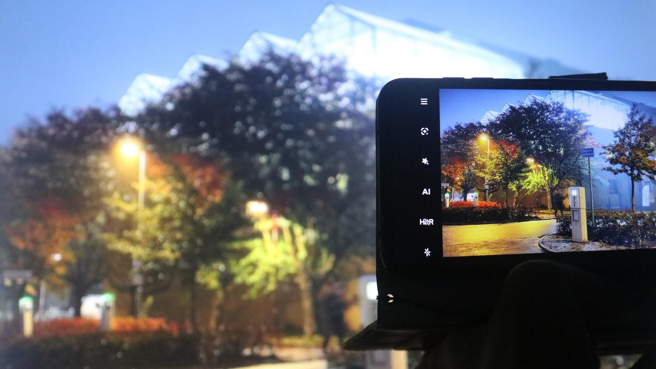 Taking a photo of trees and a building with a phone camera