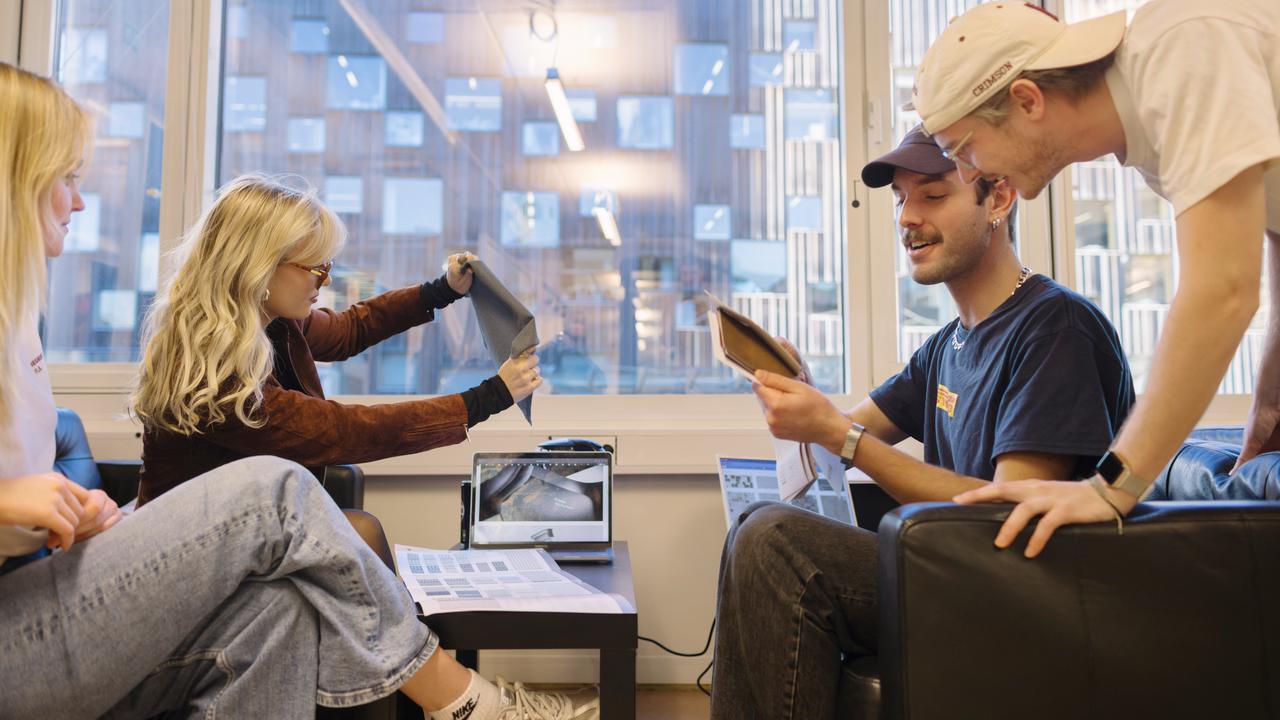 BFA students looking at fabrics samples in the BFA Studio at UID.
