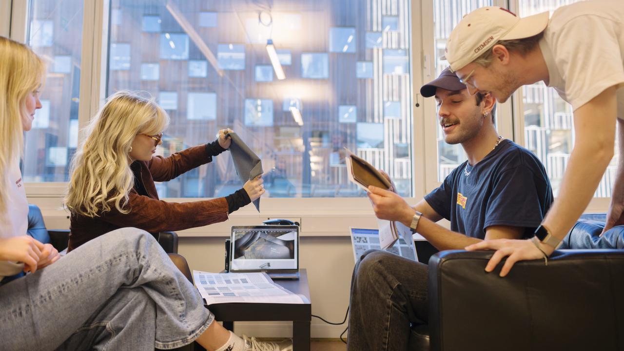 BFA students looking at fabrics samples in the BFA Studio at UID.