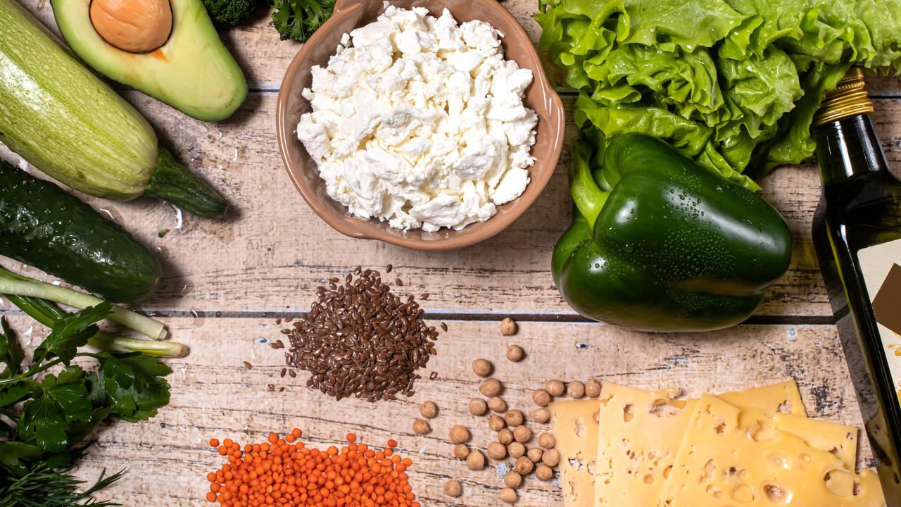 Nyttiga råvaror i form av grönsaker, baljväxter, olivolja och ost på ett bort.