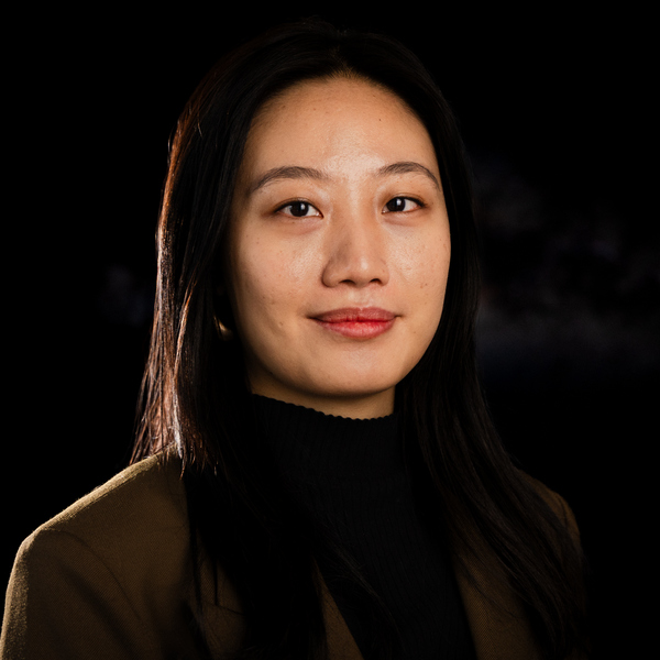 En kvinna med långt hår och svart polotröja.