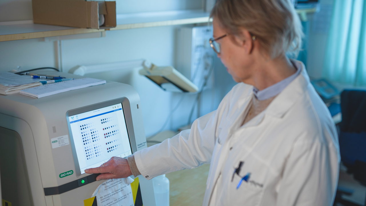 Helena Alstermark is standing by a Chemidoc imager, used to detect and visualise chemiluminescence from immunolabelled samples on a dot blot membrane.