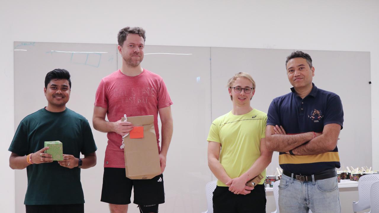 A group of men standing next to each other during an award ceremony