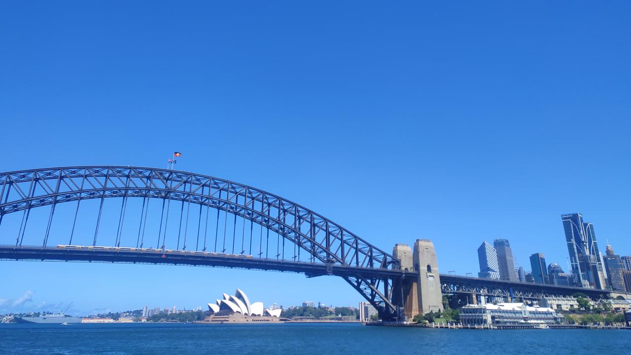 View over Sydney with a bridge and the opera house.