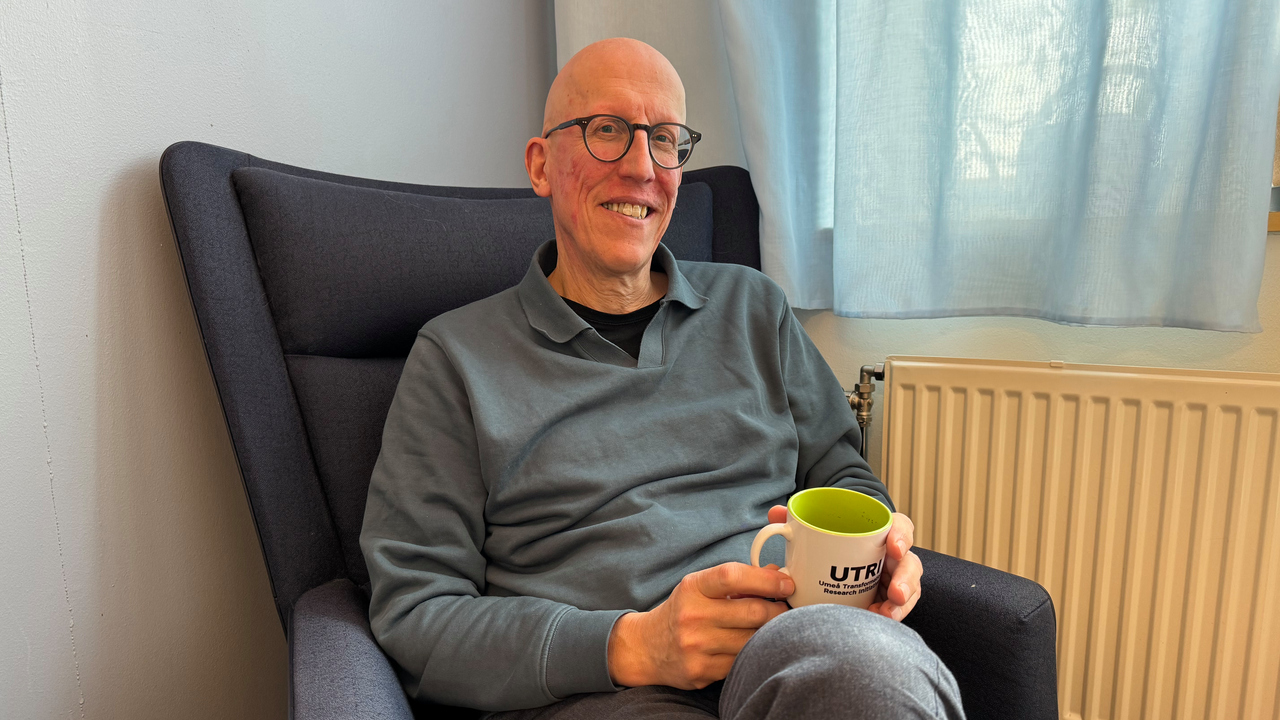 Magnus Evander relaxes with a cup of coffee between laps.