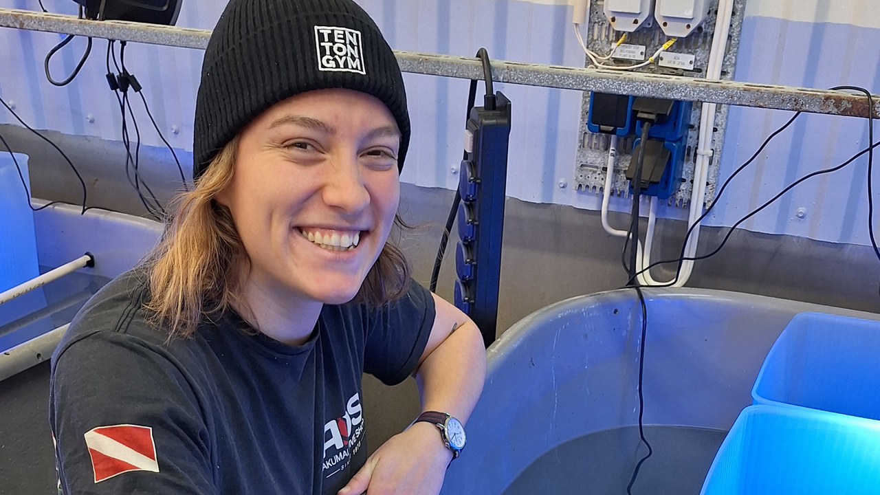 A happy woman in a lab.