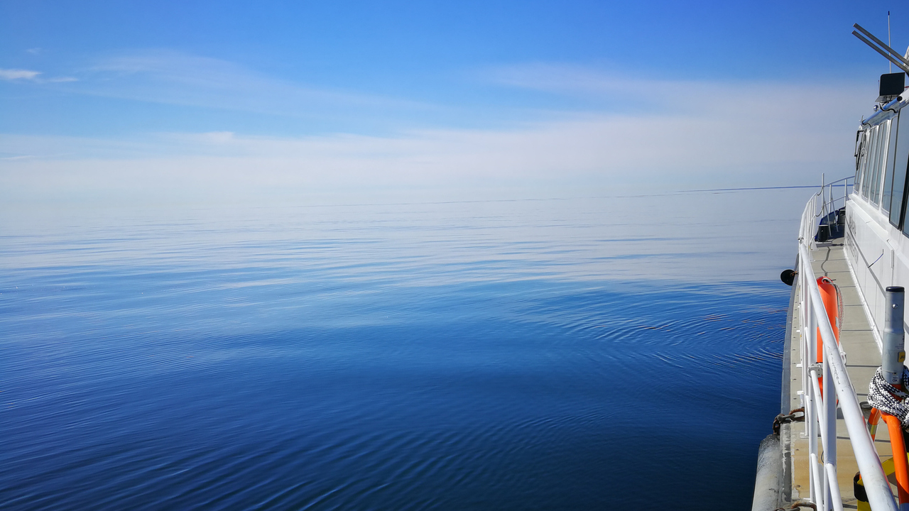 Calm water and a research vessel.