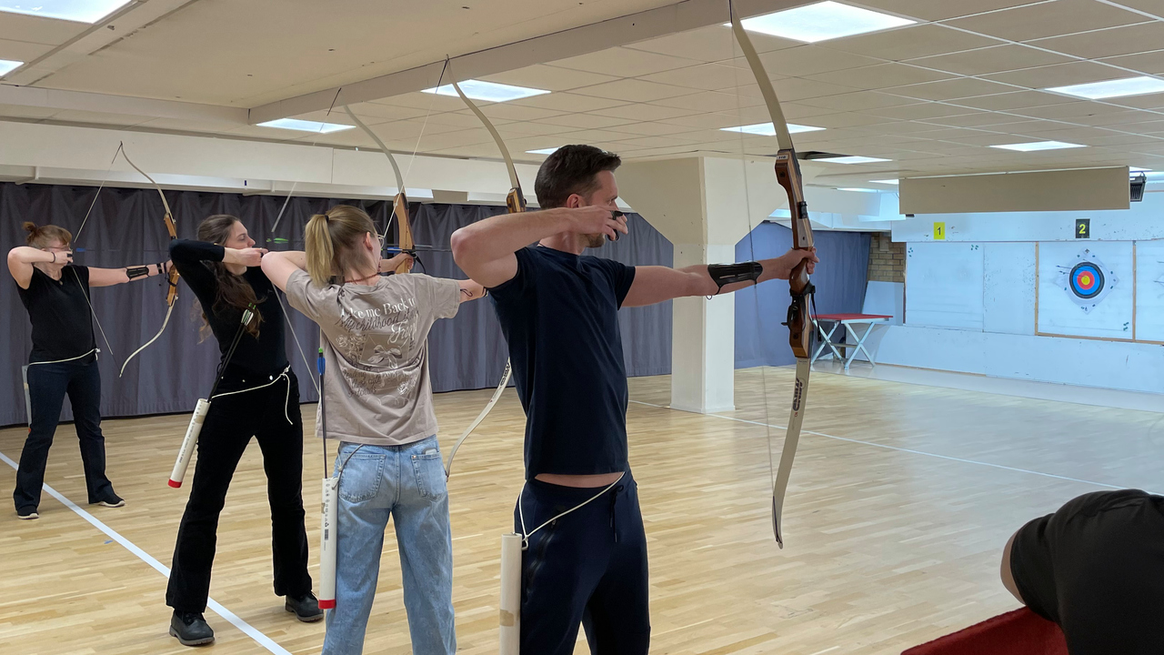 människor som skjuter bågskytte.