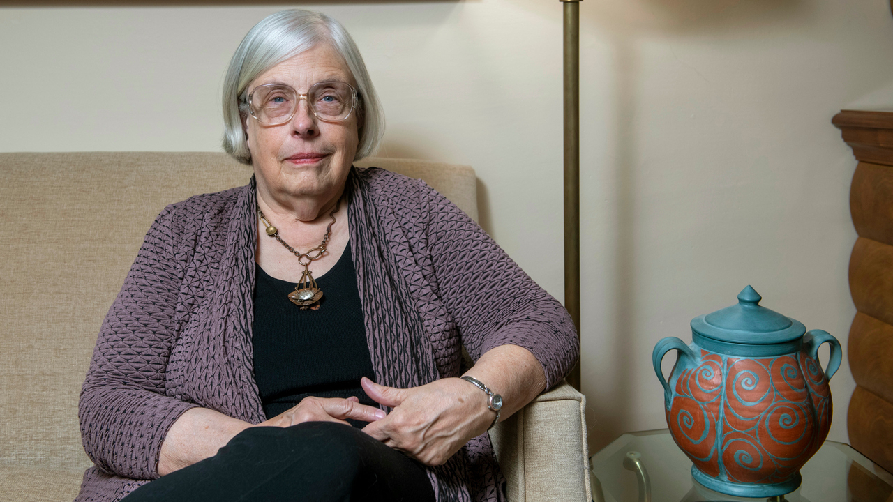 Professor Theda Skocpol sitting in a sofa in her living room