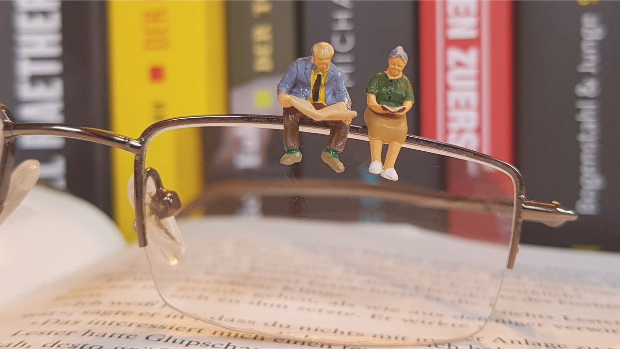 Bild på miniatyrfigurer på ett par glasögon