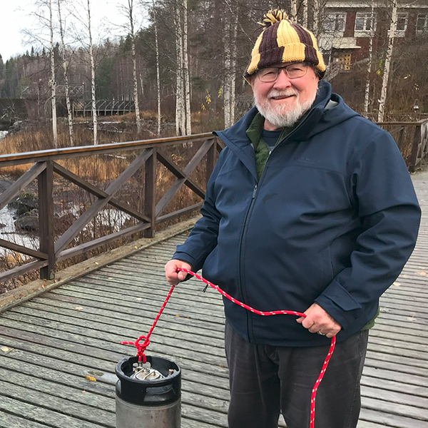a person standing on a bridge over a river.