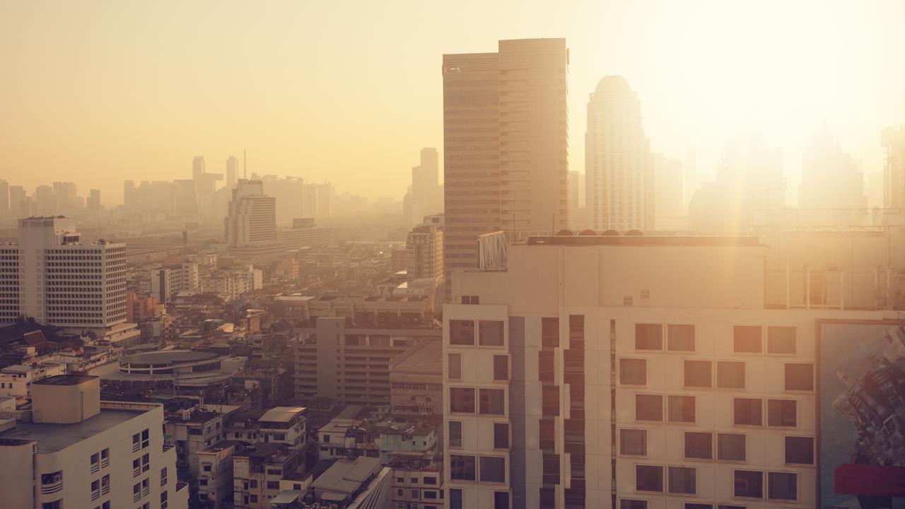 En utsikt över en disig storstad från en hög byggnad.