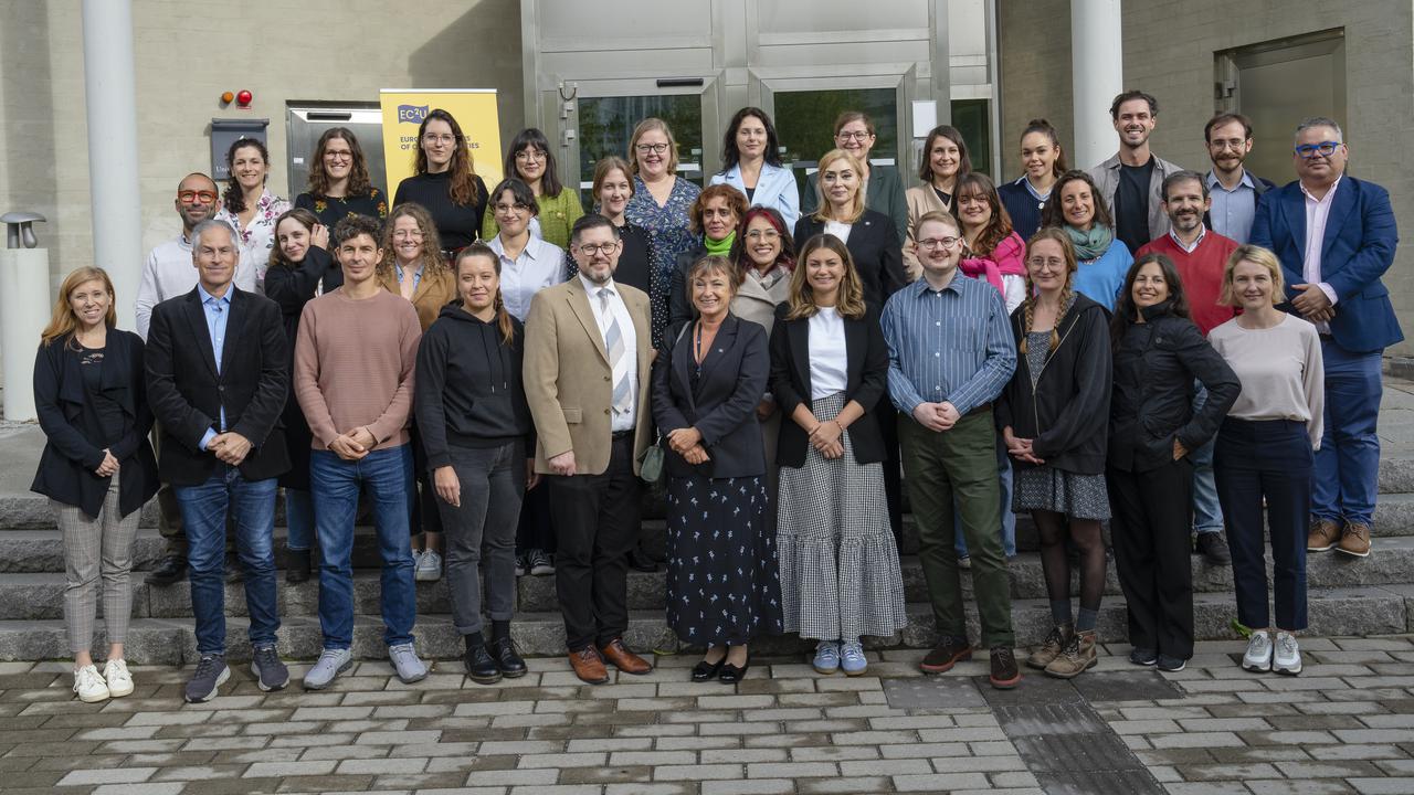 Group photo of EC2U university delegates in front of a campus building