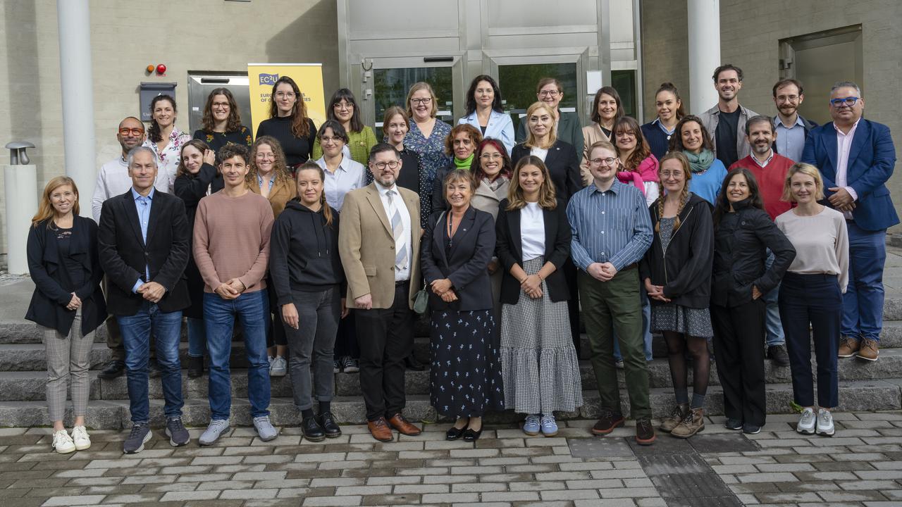 Group photo of EC2U university delegates in front of a campus building