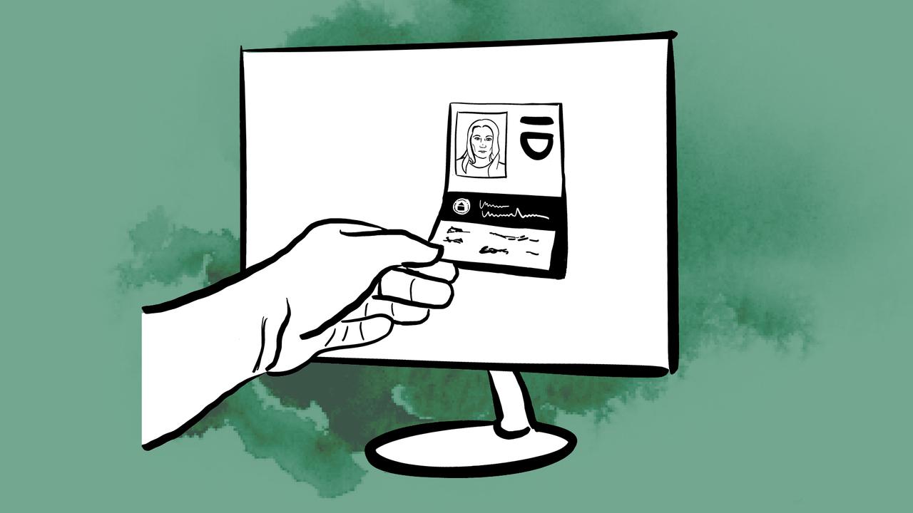 Hand plockar ut en identifikation från en dator.