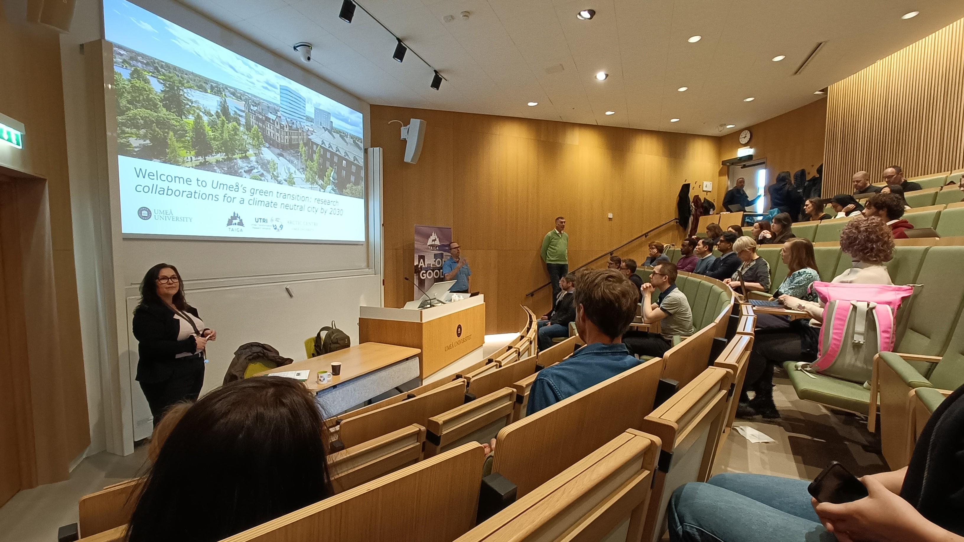 Overview of the auditorium, with Annika Egan Sjölander in front of a powerpoint