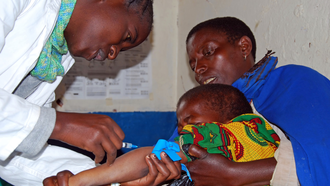 Doctor treating child in Africa