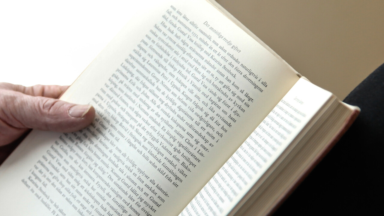 Hand holding an open book