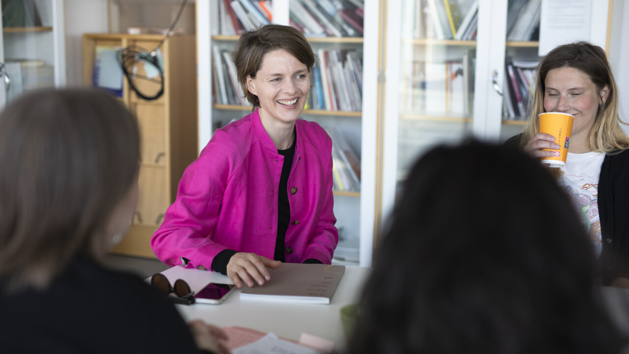 Glada personer som sitter runt ett bord.