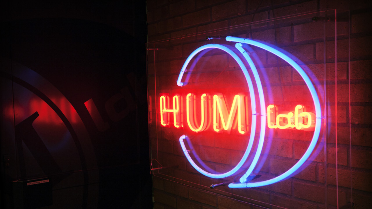 Photo of a big screen and people playing a computer game