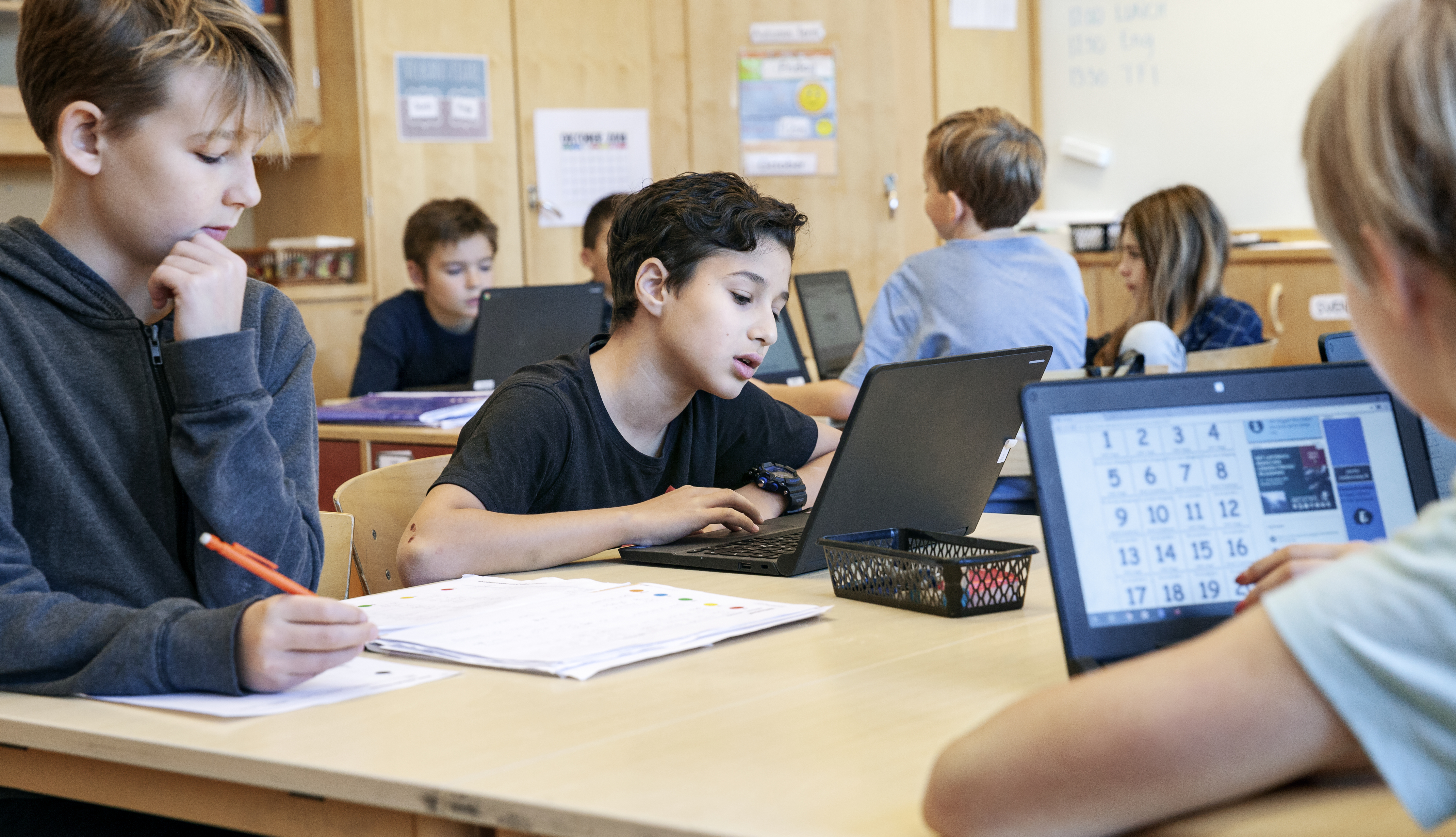 Barn i klassrum jobbar med bärbara datorer.