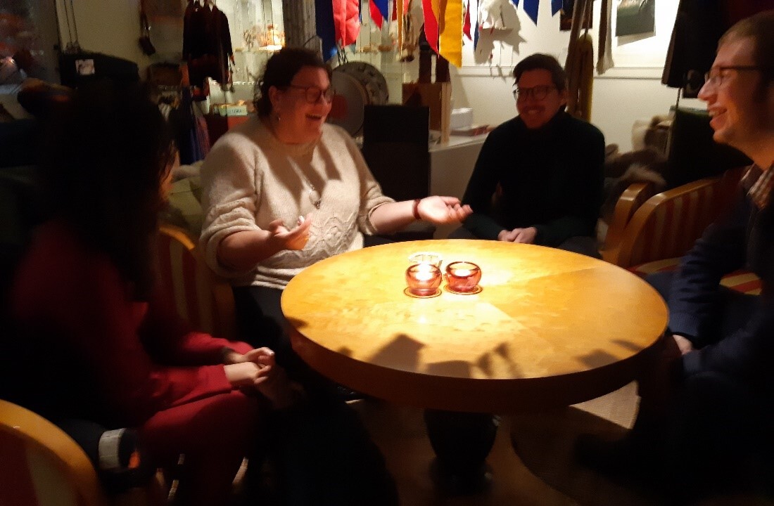 Constanze Ackermann-Boström sitter vid ett bord och diskuterar med andra.