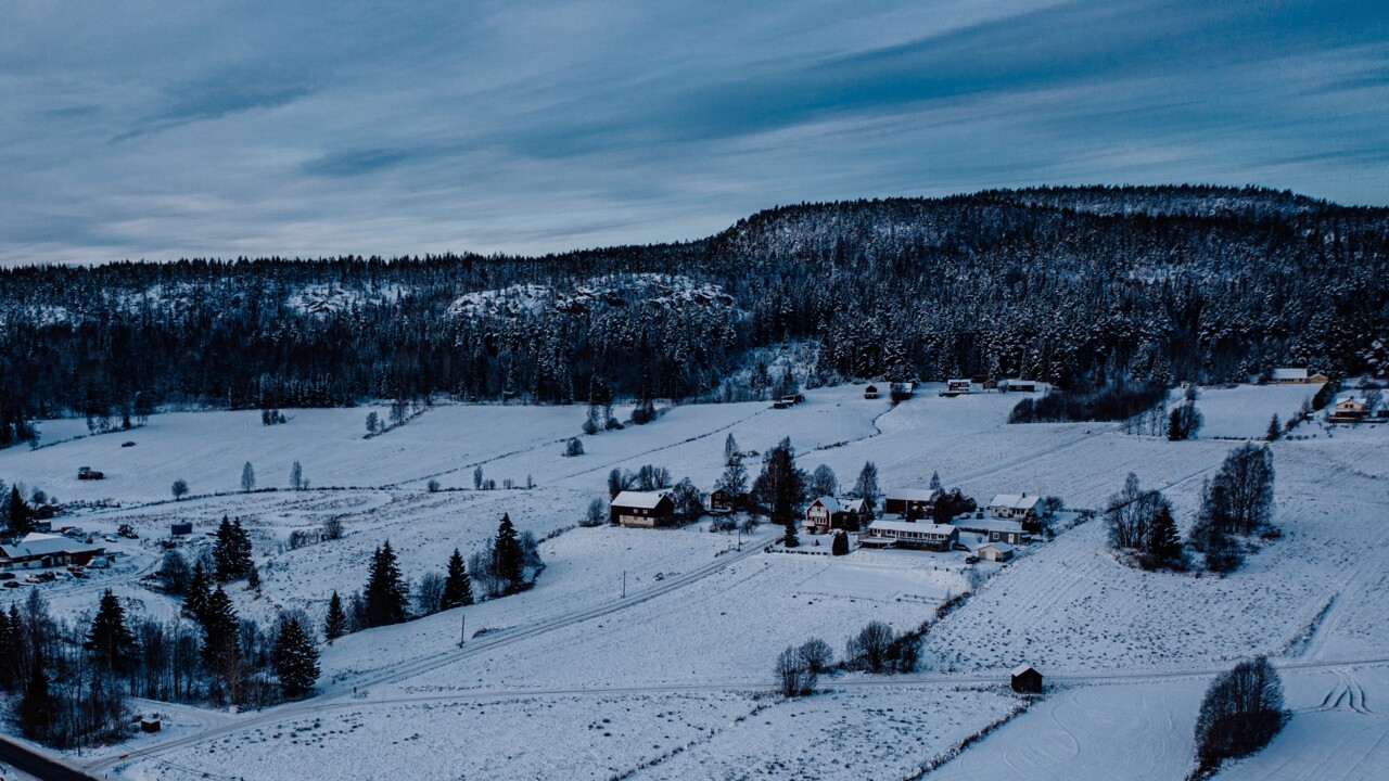a snow-covered village on a cloudy autumn day