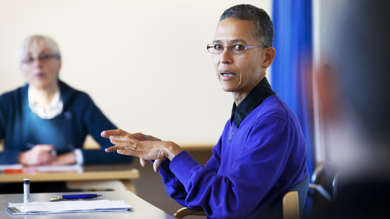 Two women around a table at a seminar