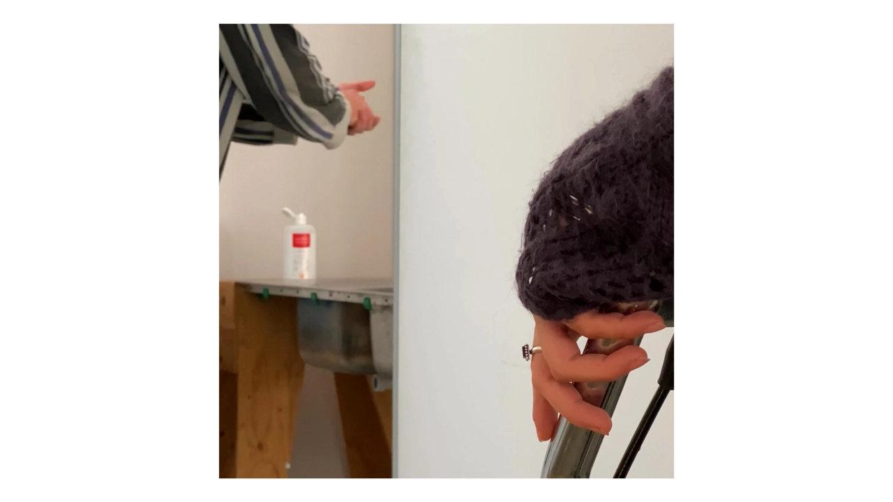 abstract image with hands showing from two persons, one using hand sanitizer