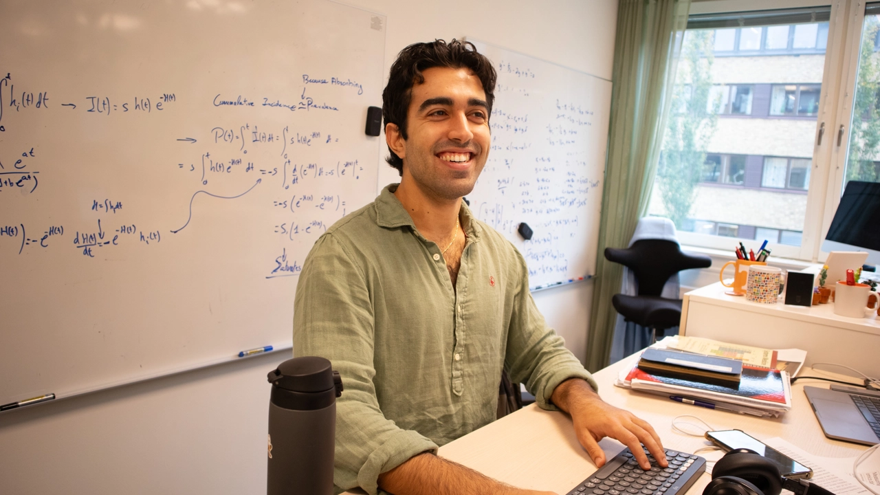 Photo of Anton Carcedo Martinez standing by his computer and desk at Icelab