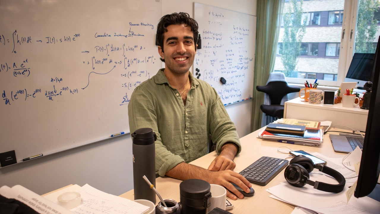 Photo of Anton Carcedo Martinez standing by his desk and computer at Icelab