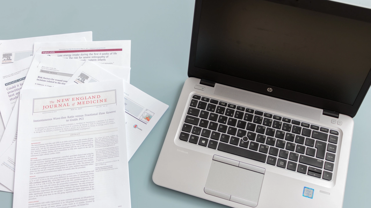 Scientific papers and a laptop