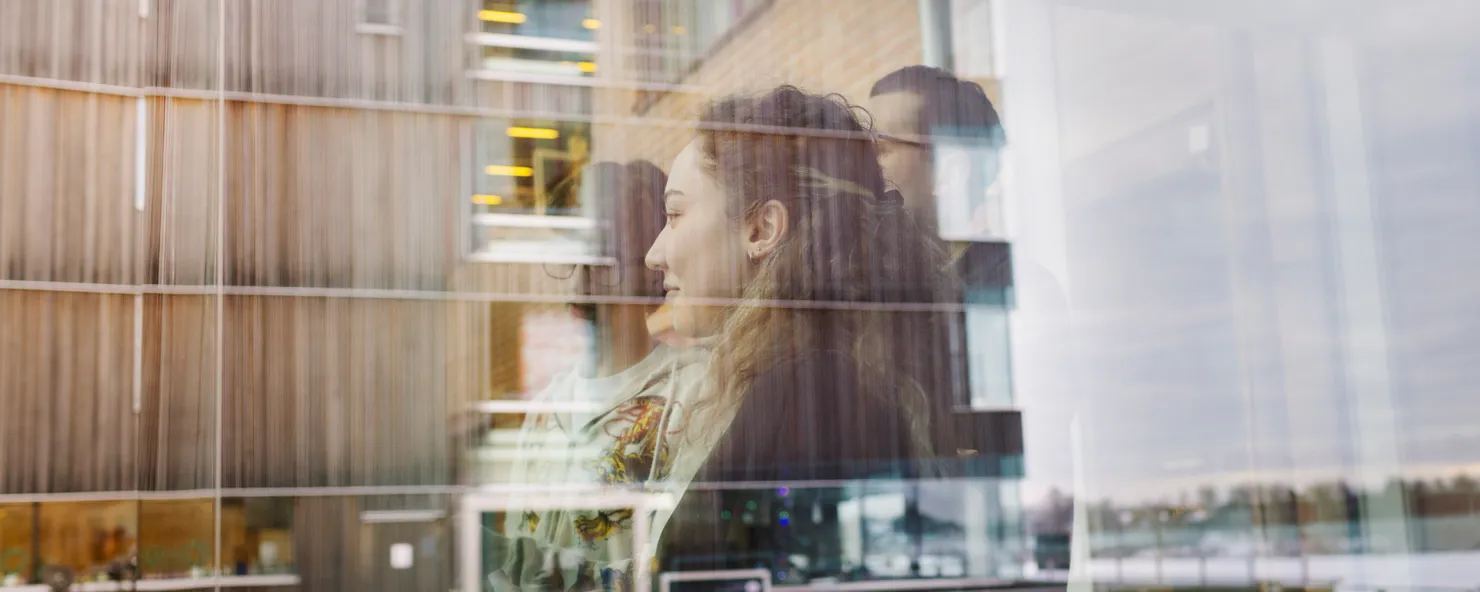 Two persons and a building in the background