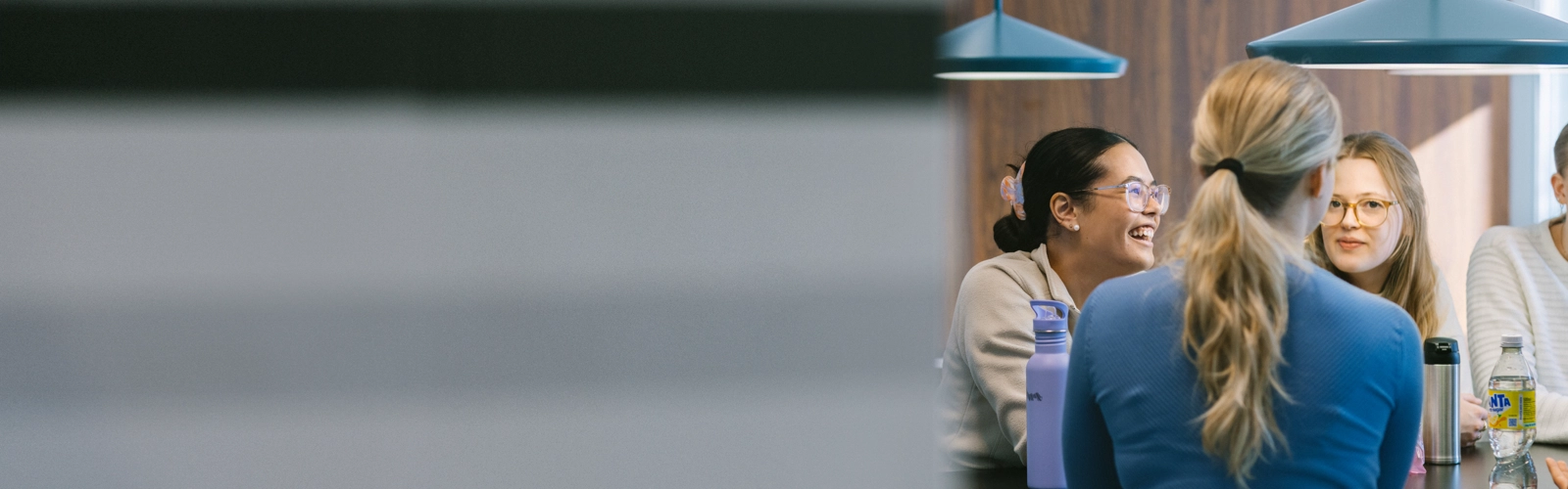 A group of women sitting around a table talking.