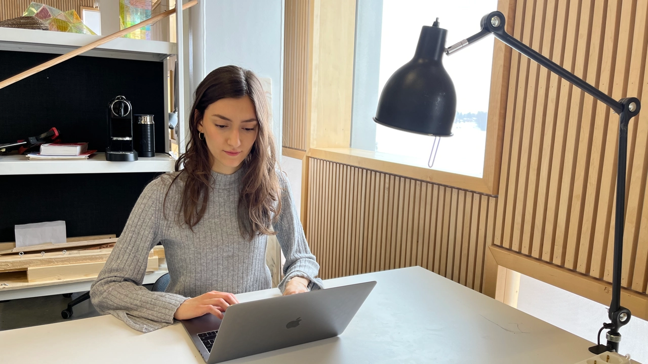 Photo of Emma Biondani working at her desk at Umeå School of Architecture
