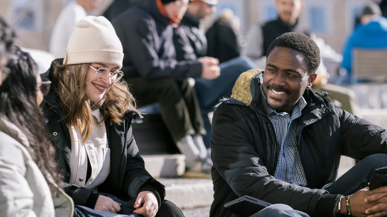 En grupp av internationella studenter ute i solen på vintern.