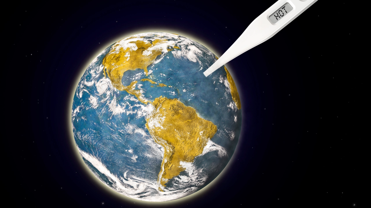 Ett jordklot med en termometer istucken som visar på hot (het) för att illustrera växthuseffekten.