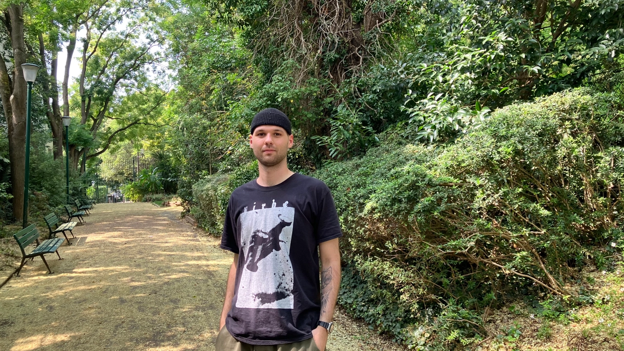 Photo of Konstantin Schäfer, in the background a forest path and trees