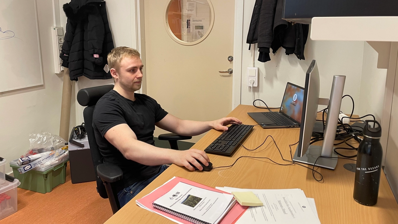 Photo of Matous Jimel sitting at his desk in front of the computer