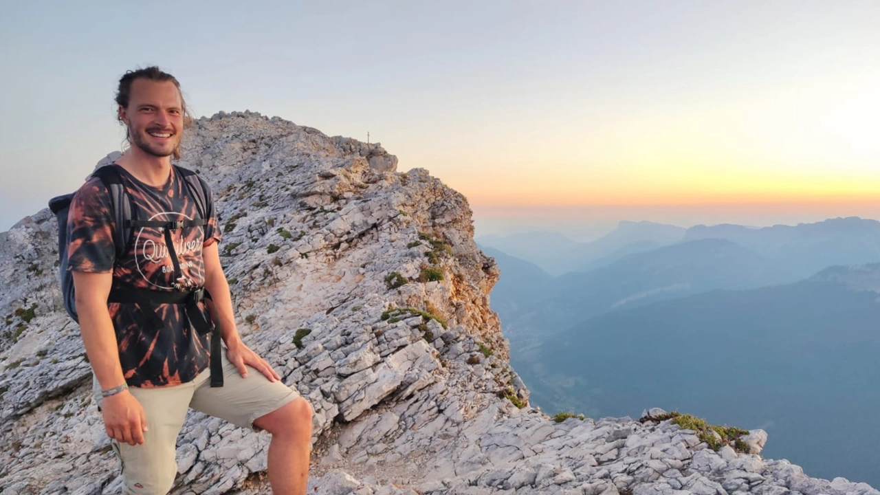 Photo of Michael Baumgärtner standing on a stony mountain top
