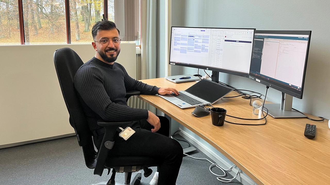 Photo of Mohammad Mshaleh sitting by the computer in Siemens Energy's office