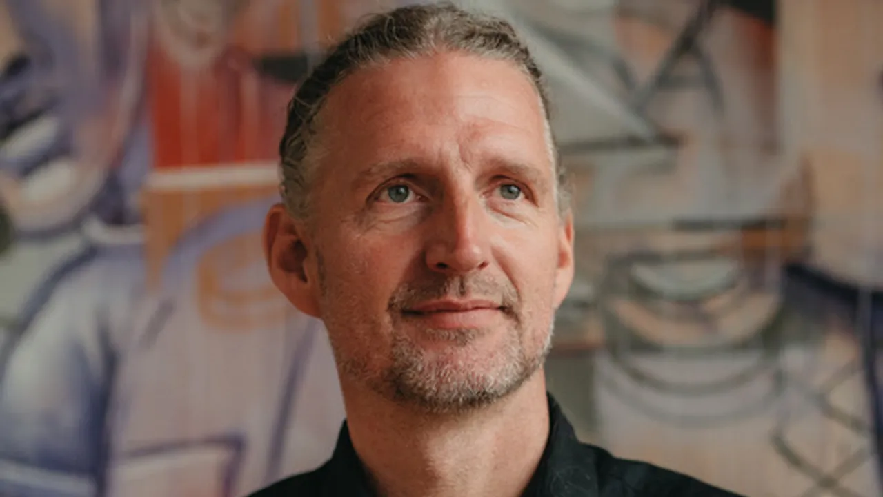 A man standing in front of a painting