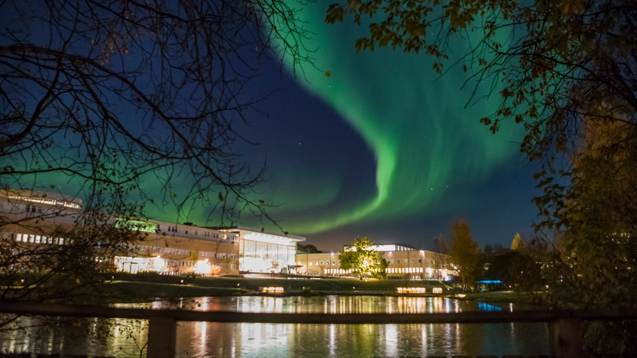 Campus by night with the Aurora Borealis in the sky