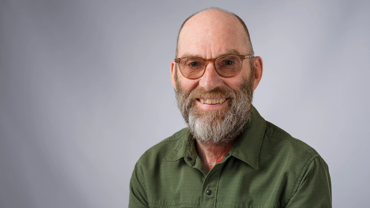 Man tittar in i kameran och ler.