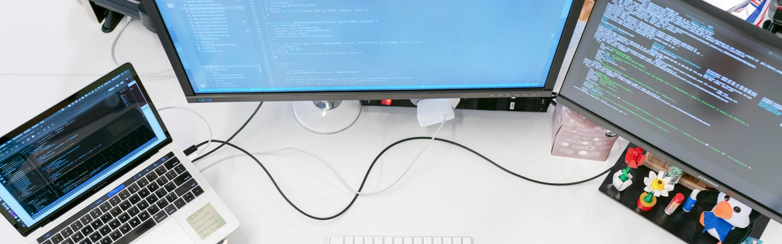 En kvinna sitter vid ett skrivbord med två datorskärmar