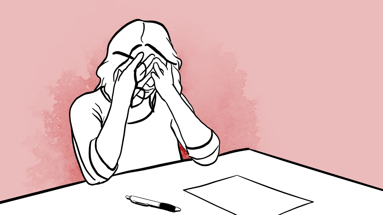 Woman with her hands over her face.