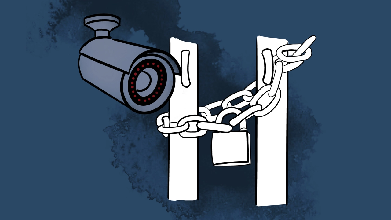 A padlock with a chain around a door opening and a surveillance camera.