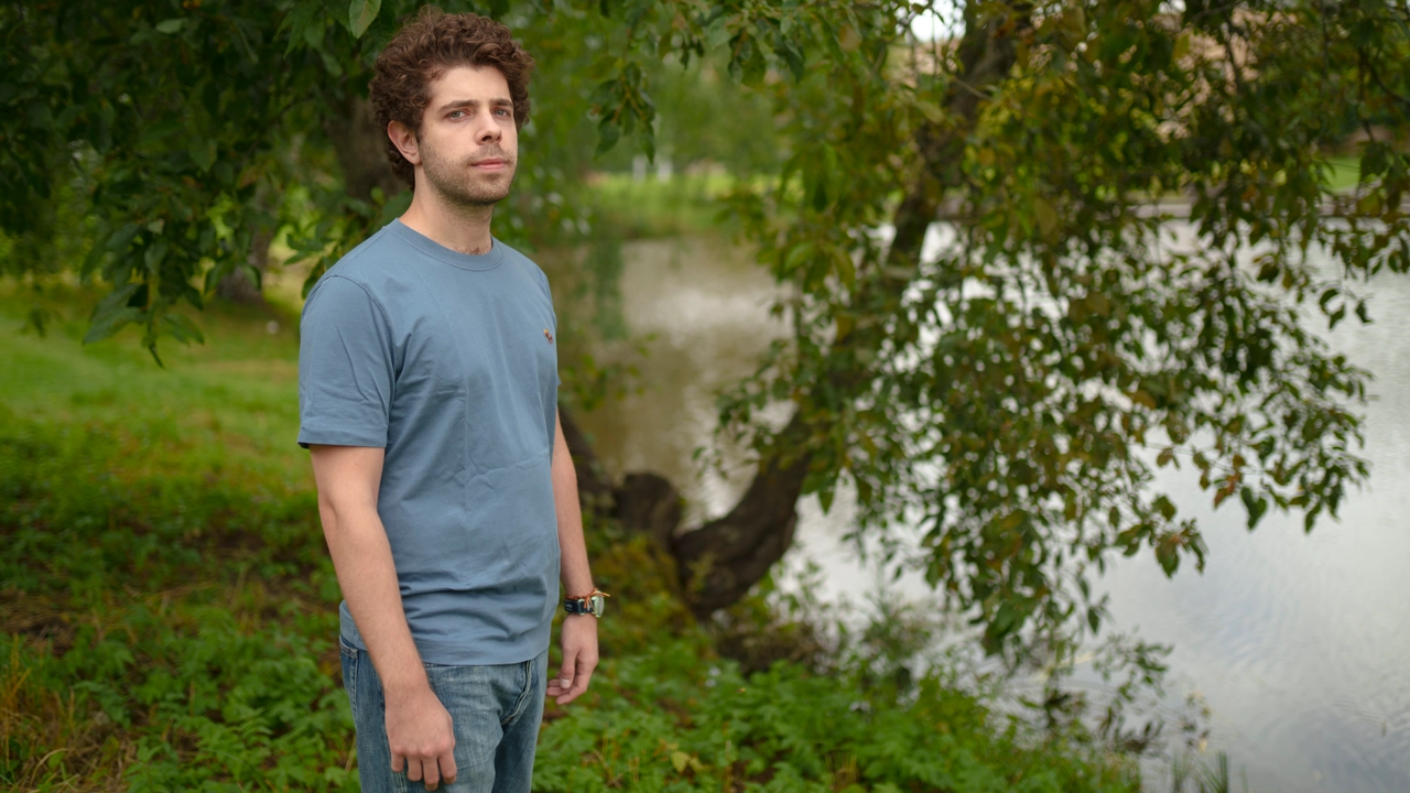 Photo of Nikiforos Staveris standing next to the campus pond