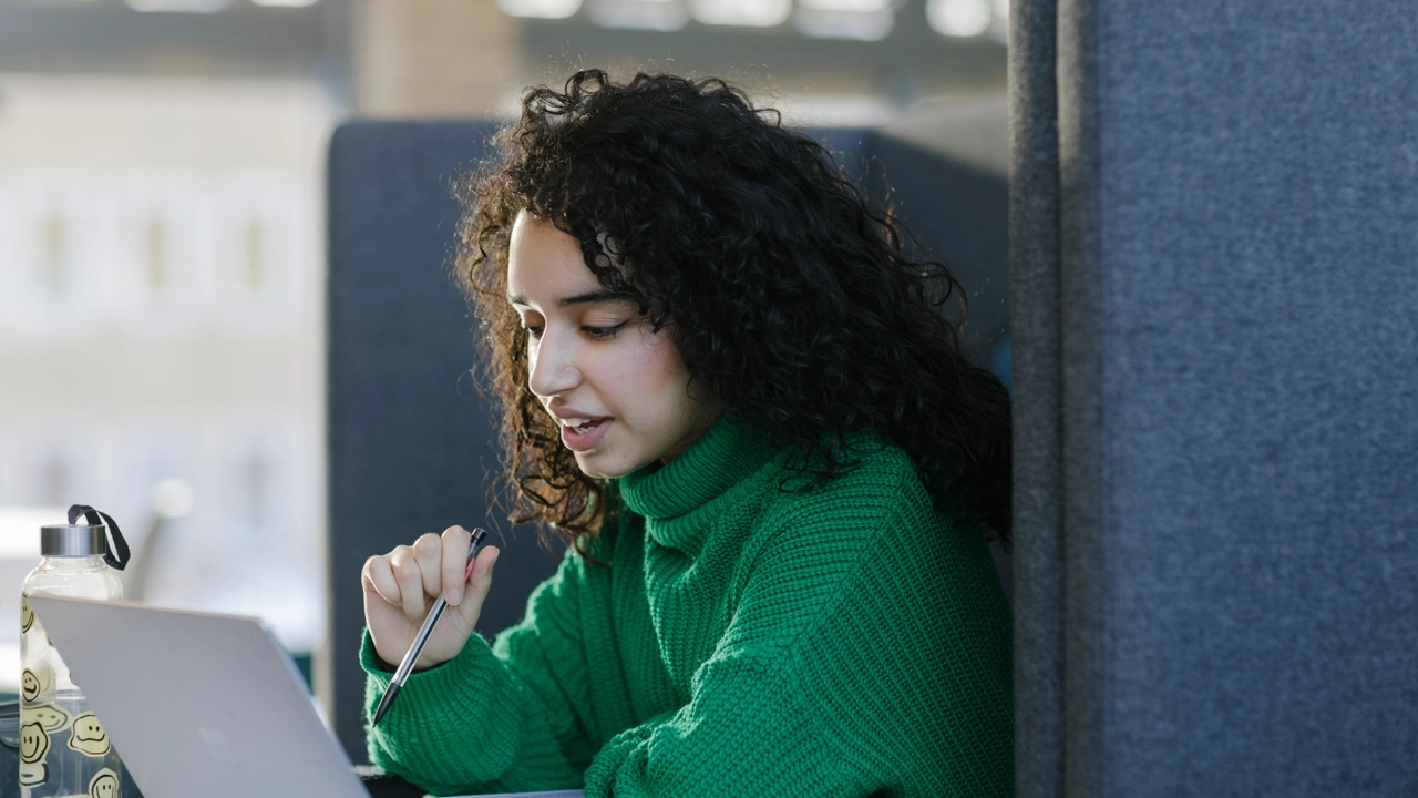 A woman is using the study spaces in the Humanities Building to study.